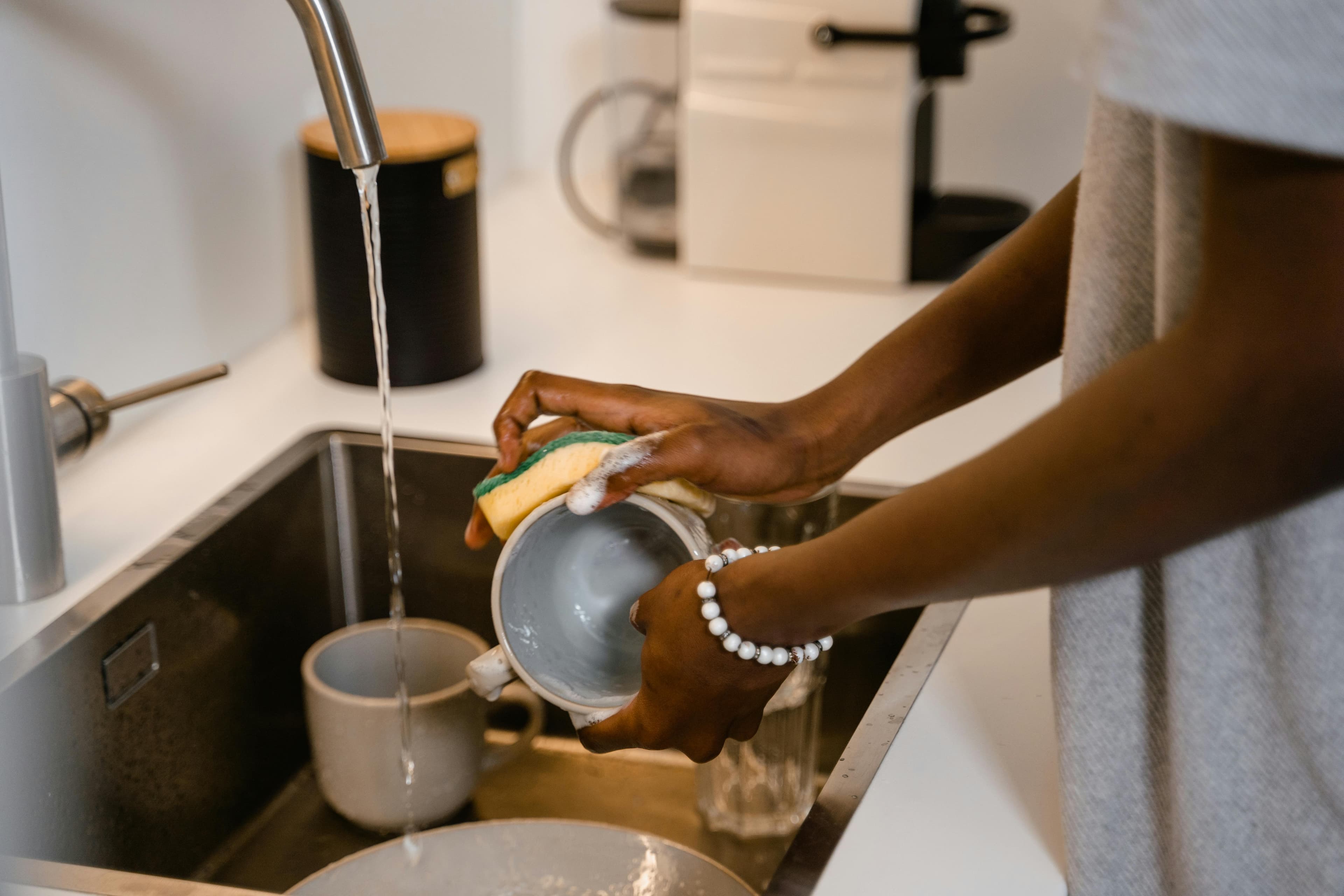 Caregiver mopping floor providing hourly cleaning and home care services
